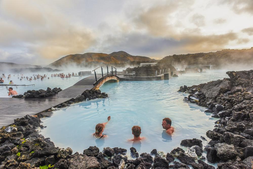 People bathe in the popular Blue Lagoon. (weniliou/Shutterstock)
