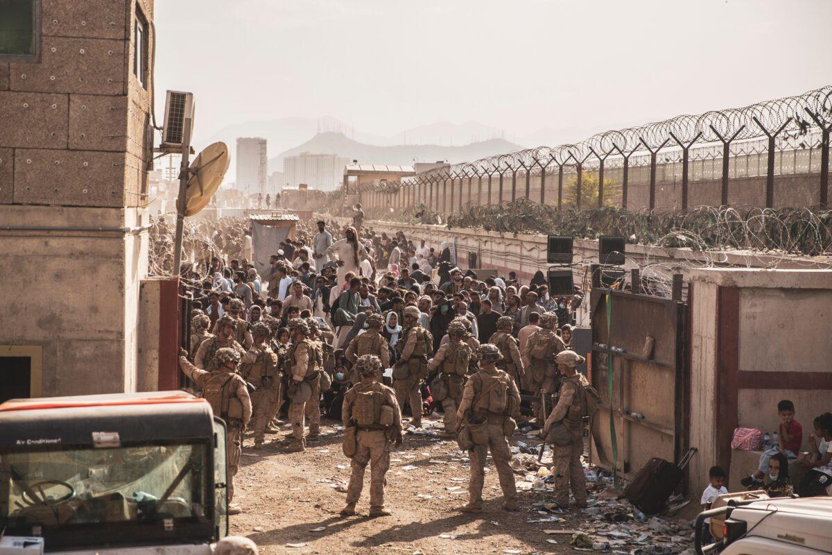U.S. Marines provide assistance at an Evacuation Control Checkpoint during an evacuation at Hamid Karzai International Airport, Afghanistan, on Aug. 22, 2021. (U.S. Marine Corps/Staff Sgt. Victor Mancilla via Reuters)
