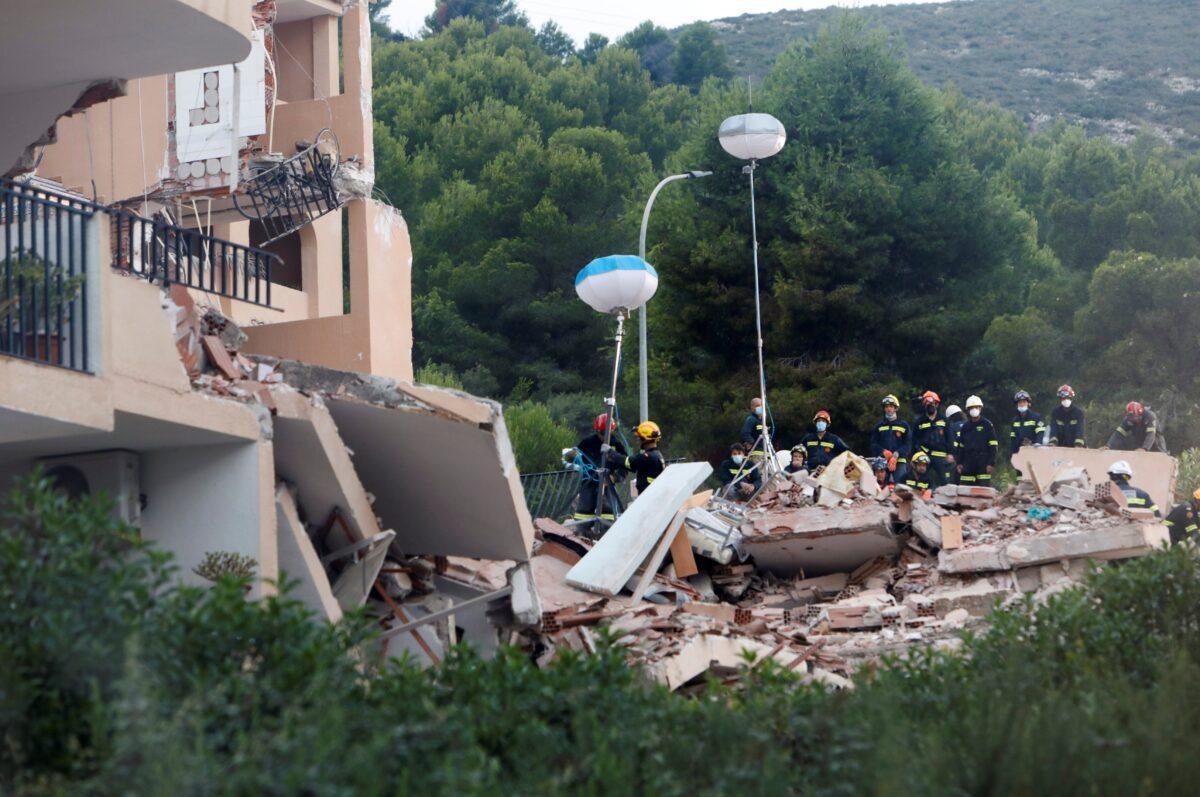 Firefighters work among the debris of a collapsed building in the town of Peniscola, Spain, on Aug. 26, 2021. (Eva Manez/Reuters)