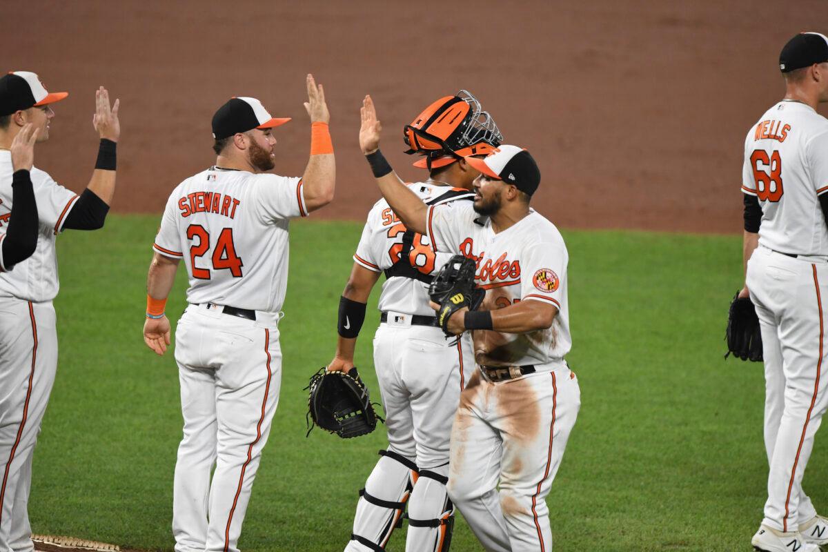 Baltimore Orioles congratulate one another after defeating the Los Angeles Angels 10-6 in a baseball game in Baltimore, on Aug. 25, 2021. (Terrance Williams/AP Photo)