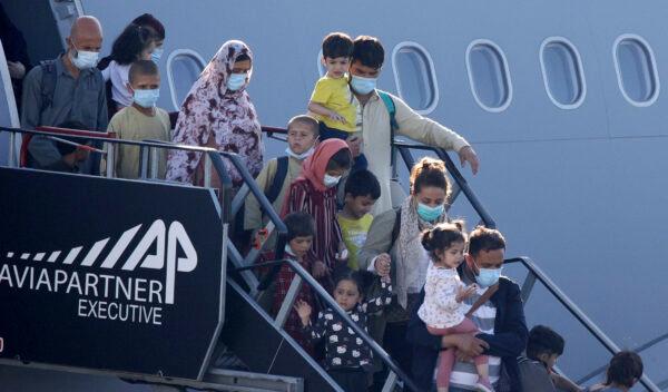 People disembark from a Belgian military plane, after being evacuated from Afghanistan, as it arrives at Melsbroek Military Airport in Melsbroek, Belgium, on Aug. 25, 2021. (Olivier Matthys/AP Photo)