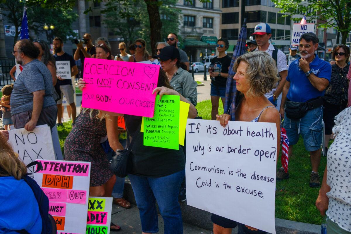Protesters demonstrated near the Park Street subway station and then marched to the Massachusetts Department of Public Health in Boston, Mass., on Aug 25, 2021. (Learner Liu/The Epoch Times)