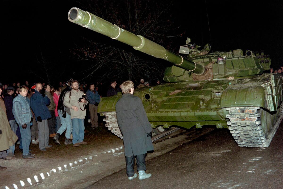 A Lithuanian demonstrator stands in front of a Soviet Red Army tank during the assault on the Lithuanian Radio and Television station in Vilnius on Jan. 13, 1991. Thirty years ago, the Baltic republic of Lithuania declared independence, heralding the start of the break-up of the 15-member Soviet Union, which imploded in Dec. 1991. (STF/AFP via Getty Images)