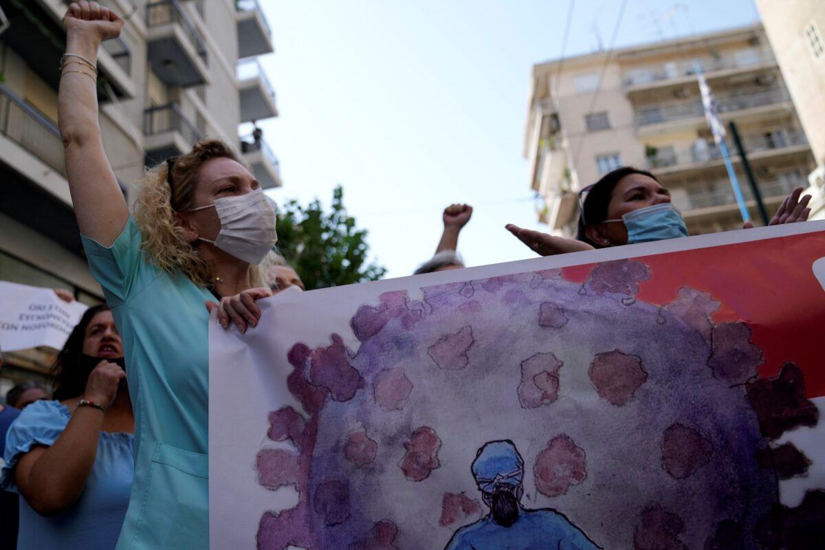 Health workers take part in a rally in Athens, on Aug. 26, 2021. (Thanassis Stavrakis/AP Photo)