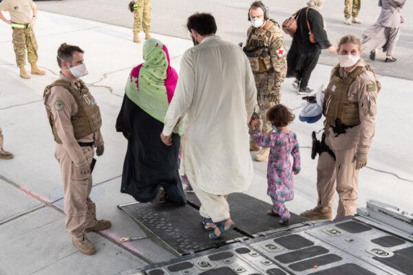 Evacuees arrive onboard the first Royal New Zealand Air Force C-130H(NZ) Hercules flight to an airbase in the United Arab Emirates on Aug. 26, 2021. (<a href="https://www.nzdf.mil.nz/nzdf/news/hercules-completes-second-flight-from-kabul-with-evacuees/">New Zealand Defence Force</a>)
