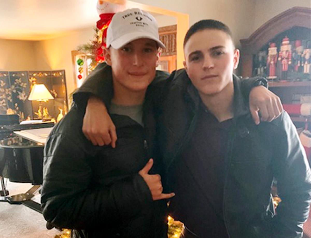 This December 2019 photo provided by Regi Stone shows Eli Stone (L) and Rylee McCollum at Christmas in Stone's house in Jackson, Wyo. Rylee McCollum, of Bondurant, Wyo., was one of the U.S. Marines killed in the suicide bombing at the Kabul airport in Afghanistan according to his sister, Roice McCollum. (Regi Stone via AP)