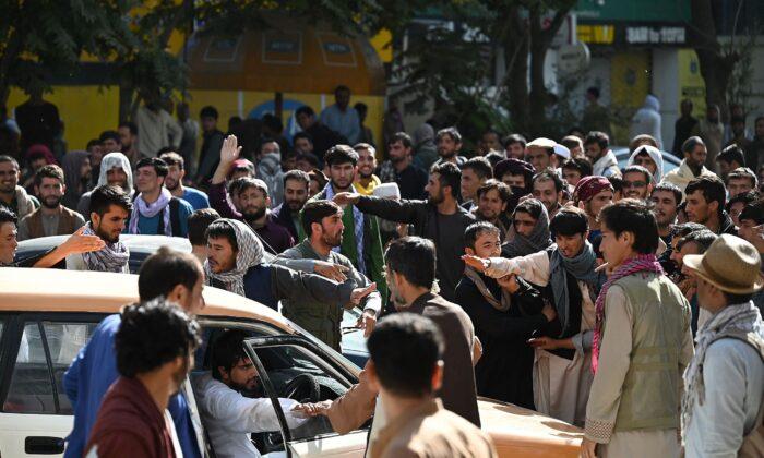 The Latest: Afghans Protest at Kabul Bank, Long ATM Lines