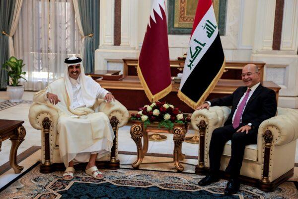 Iraq's President Barham Salih meets Qatar's Emir Sheikh Tamim bin Hamad al-Thani during the welcome ceremony ahead of the Baghdad summit at the Green Zone in Baghdad, Iraq, on Aug. 28, 2021. (Thaier Al-Sudani/Reuters)