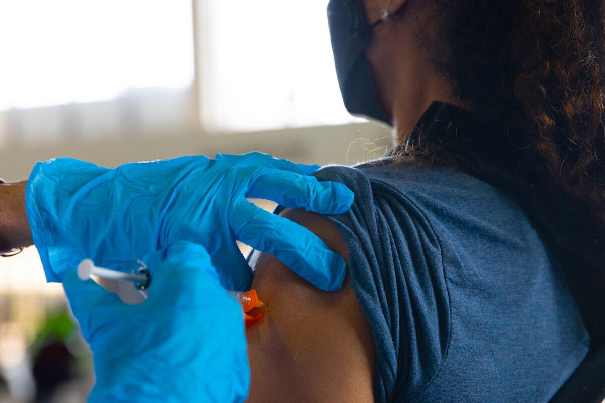 A patient receives her booster dose of the Pfizer-BioNTech COVID-19 vaccine at the Southfield Pavilion in Southfield, Michigan, on Aug. 24, 2021. (Emily Elconin/Getty Images)