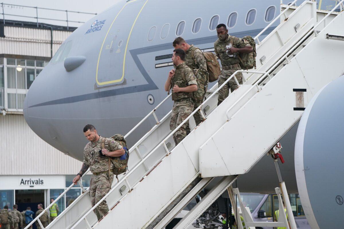 Members of the British armed forces 16 Air Assault Brigade walk to the air terminal after departing a flight from Afghanistan at RAF Brize Norton, in Oxfordshire, UK, on Aug. 29, 2021. (Jonathan Brady/PA)