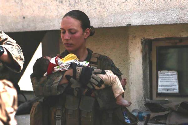 Sgt. Nicole Gee holding a baby at Hamid Karzai International Airport in Kabul, Afghanistan in an undated photo. (U.S. Department of Defense via AP)