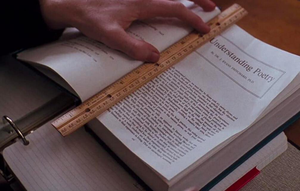 A student in teacher John Keating's (Robin Williams) poetry class gets ready to rip out a page, in "Dead Poets Society." (Touchstone Pictures/Warner Bros)