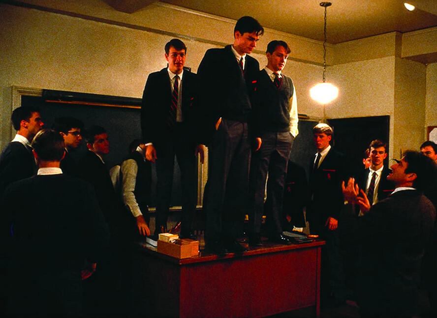 (L–R, on desk) Knox Overstreet (Josh Charles), Neil Perry (Robert Sean Leonard), and Charlie Dalton (Gale Hansen) try getting a new perspective on life, in "Dead Poets Society." (Touchstone Pictures/Warner Bros)