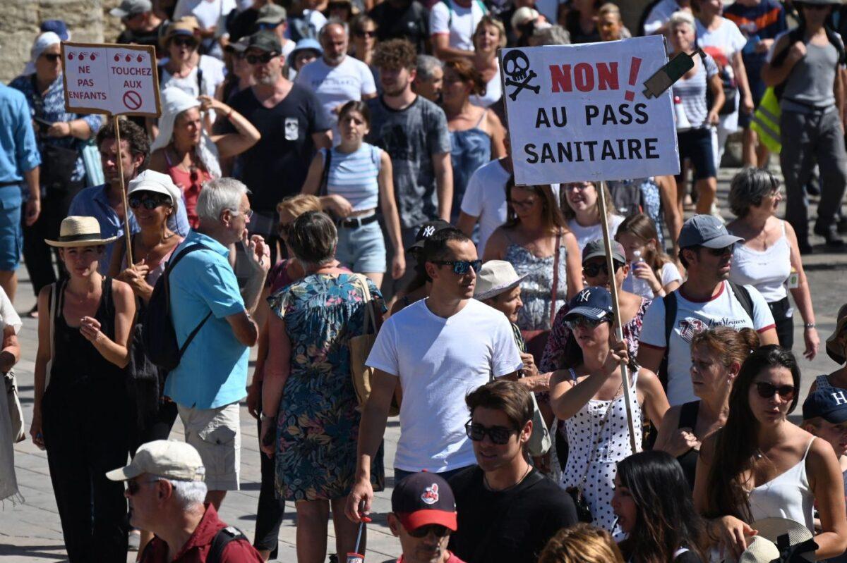 A demonstrator holds a placard reading "No to health pass" during a national day of protest in Montpellier, France, on Aug. 28, 2021. (Sylvain Thomas/AFP via Getty Images)