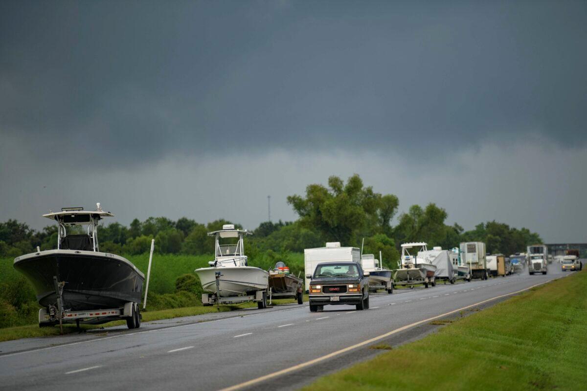 Boats, trailers and RVs line Louisiana Highway 46 after owners moved them to be inside the levee protection zone before Hurricane Ida makes landfall in St. Bernard Parish, La., on Aug. 28, 2021. (Matthew Hinton/AP Photo)