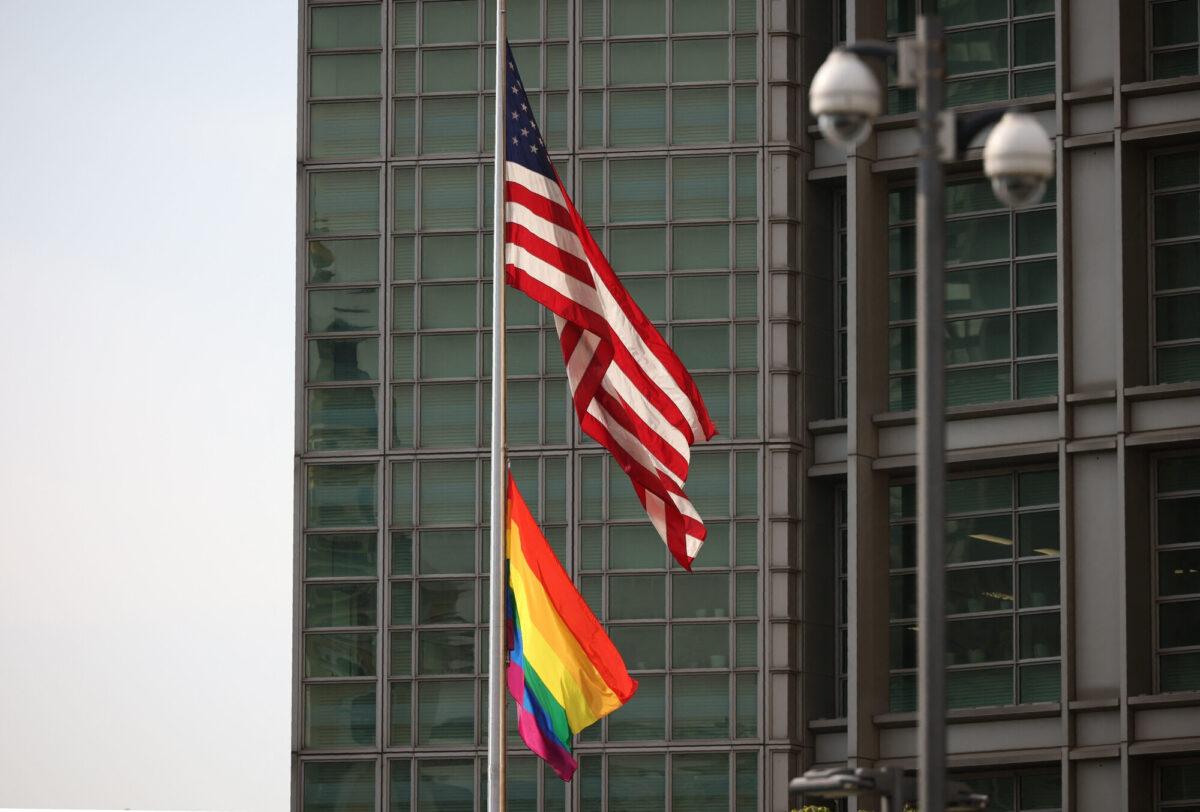 A rainbow flag hangs below the American flag near the entrance to the U.S. embassy in Moscow, on June 25, 2021. (Dimitar Dilkoff/AFP via Getty Images)