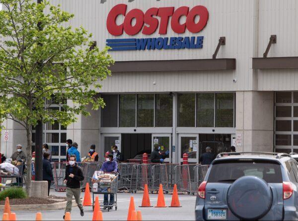 Shoppers walk out with full carts from a Costco store in Washington, on May 5, 2020. (Nicholas Kamm/AFP via Getty Images)
