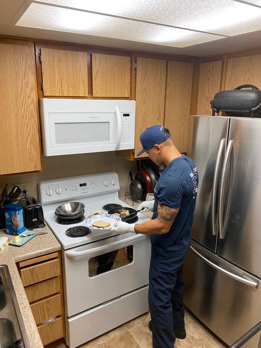 A firefighter cooks breakfast for an elderly woman who had fallen. (Courtesy of the Orange County Fire Authority)