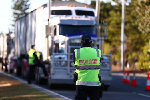 Queensland Police stop trucks at the Queensland border in Coolangatta, Australia, on Aug. 25, 2021 (Chris Hyde/Getty Images)