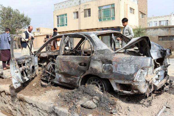 Journalists take photos of a vehicle damaged by a rocket attack in Kabul, Afghanistan, on Aug. 30, 2021. (Khwaja Tawfiq Sediqi/AP Photo)