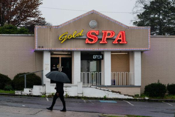 A man walks past a spa where three women were shot and killed in Atlanta, Ga., on March 17, 2021. (Elijah Nouvelage/Getty Images)