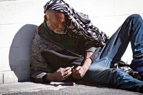 A man using drugs in Los Angeles, Calif., on June 9, 2021. (John Fredricks/The Epoch Times)