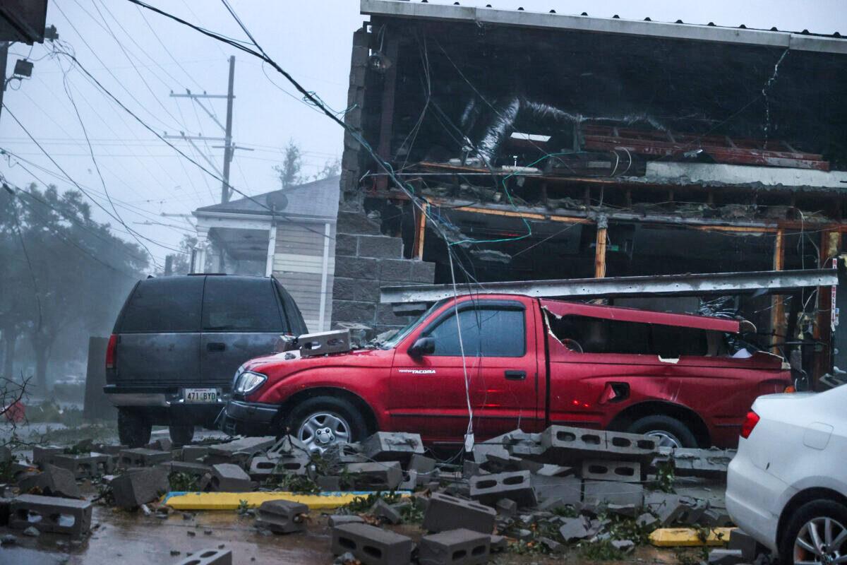 Vehicles are damaged after the front of a building collapsed during Hurricane Ida in New Orleans on Aug. 29, 2021. (Scott Olson/Getty Images)