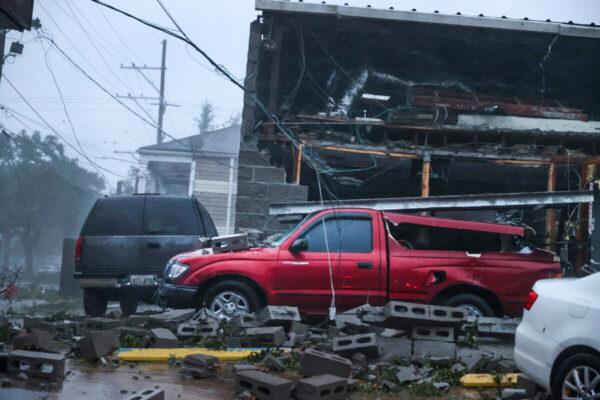 Vehicles are damaged after the front of a building collapsed during Hurricane Ida in New Orleans, La.. on Aug. 29, 2021. (Scott Olson/Getty Images)