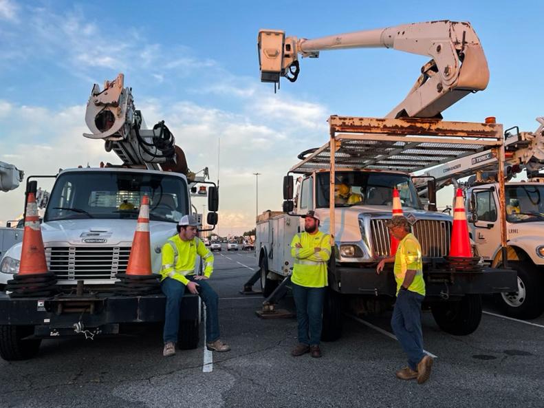 Power company workers from South Carolina and Texas wait in a mall parking lot to be assigned an area to fix, in Baton Rouge, La., on Aug. 31, 2021. (Charlotte Cuthbertson/The Epoch Times)