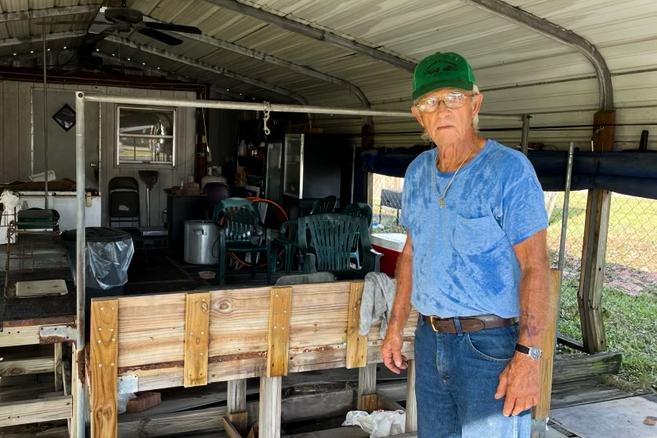 Ferrel Bailey, 78, cleans up after Hurricane Ida hit his shrimp shop on Main Street in LaPlace, La., on Aug. 31, 2021. (Charlotte Cuthbertson/The Epoch Times)