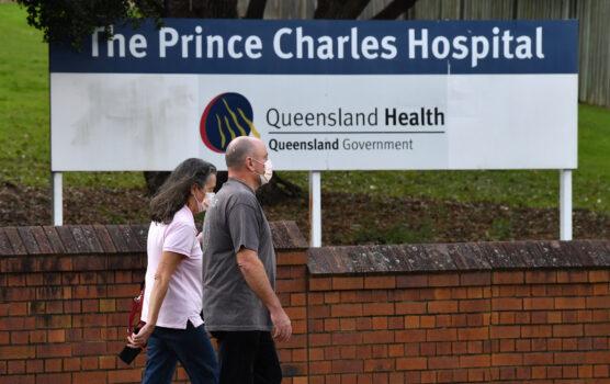 People wearing protective face masks are seen at the entry to Prince Charles Hospital in Brisbane, Australia, on June 30, 2021. (AAP Image/Darren England)