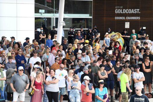 Gold Coast residents are seen with their backs turned to the Gold Coast City Council during a ‘Silent Protest’ at Bundall on the Gold Coast, Australia, on Aug. 31, 2021. “Pro-Choice” protests have been carried out in dozens of locations in all states and territories, borne out of opposition towards mandatory vaccinations for authorised workers – including truck drivers – from 12 local government areas in Sydney. (AAP Image/Dave Hunt)