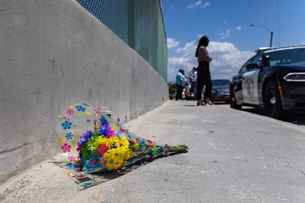  Officers, civilians, and media stand on an overpass next to an area on the 55 Freeway where a shooting stimulated from road rage happened on the morning of May 21, 2021. Orange, Calif. (John Fredricks/The Epoch Times)