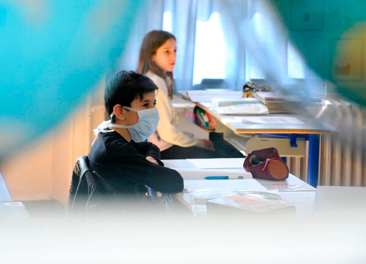 A pupil wearing a face mask attends a class in a file photo. (JEAN-CHRISTOPHE VERHAEGEN/AFP via Getty Images)