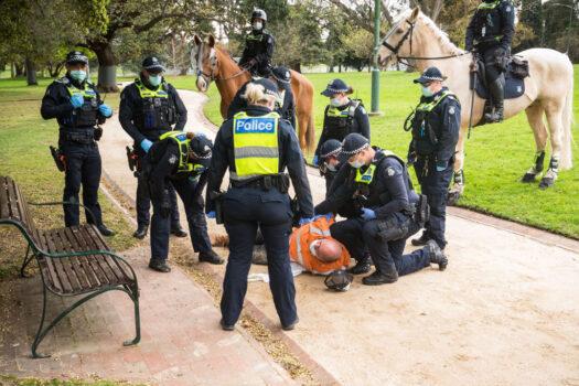 A man is detained by members of Victoria Police during a protest near Government House in Melbourne, Australia, on Aug. 31, 2021. (Darrian Traynor/Getty Images)
