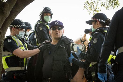 A man is detained by members of Victoria Police during a protest near Government House in Melbourne, Australia, on Aug. 31, 2021. (Darrian Traynor/Getty Images)