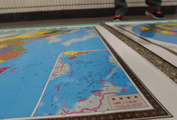 A map designed by China including an insert with nine dash lines shows the Chinese regime's claimed territory in the South China Sea in Beijing, China, on June 15, 2016. It came three days after the Hague’s Permanent Court of Arbitration invalidated Beijing’s claim. (GREG BAKER/AFP via Getty Images)