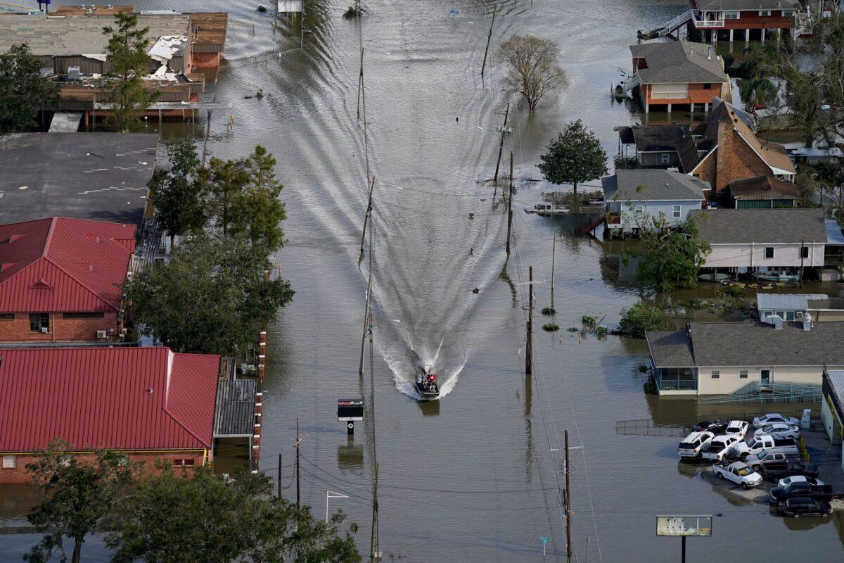 An Airboat glides over a city street in the aftermath of Hurricane Ida, in Lafitte, La., on Aug. 30, 2021. (David J. Phillip/AP Photo)