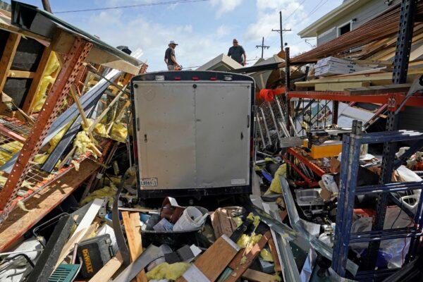 Residents work to clear debris from their storage unit which was destroyed by Hurricane Ida, in Houma, La., on Aug. 30, 2021. (David J. Phillip/AP Photo)