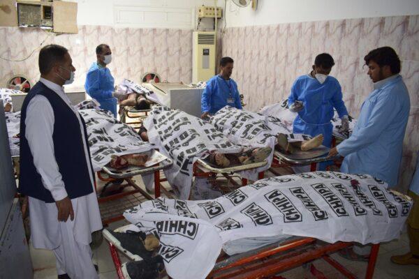 Pakistani paramedical personnel stand next to the covered bodies of suspect ISIS terrorists who were killed by security forces at a morgue in Quetta, Pakistan, on Aug. 31, 2021. (Arshad Butt/AP Photo)