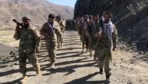 In this still image taken from video, anti-Taliban resistance troops walk in Panjshir Valley, Afghanistan, on Aug. 25, 2021. (Aamaj News Agency via Reuters)