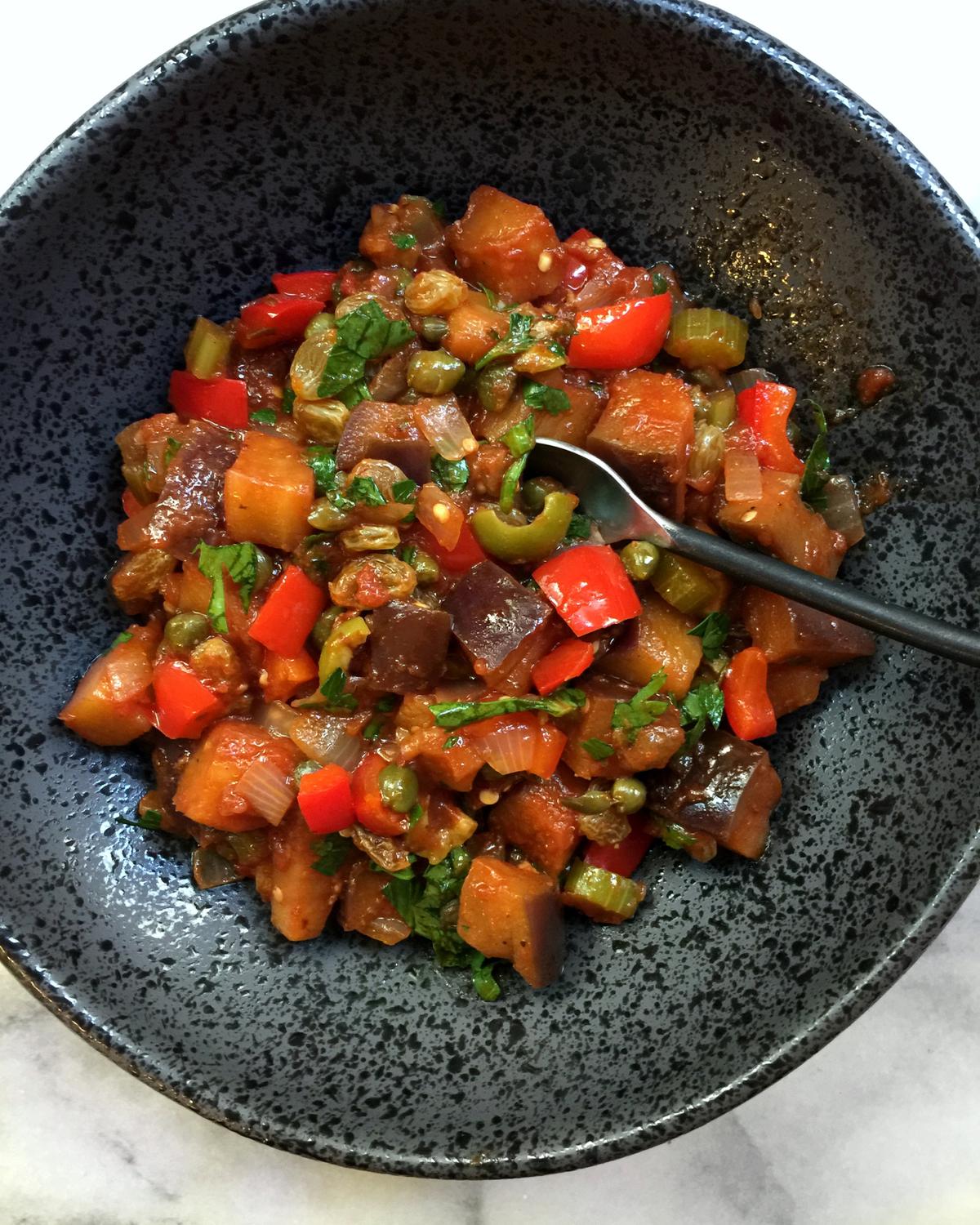 Eggplant is the dominant vegetable in caponata, cooked until golden and squidgy, and punctuated with briny olives and capers, laced with vinegar, and refreshed with sweet raisins and honey. (Lynda Balslev for Tastefood)