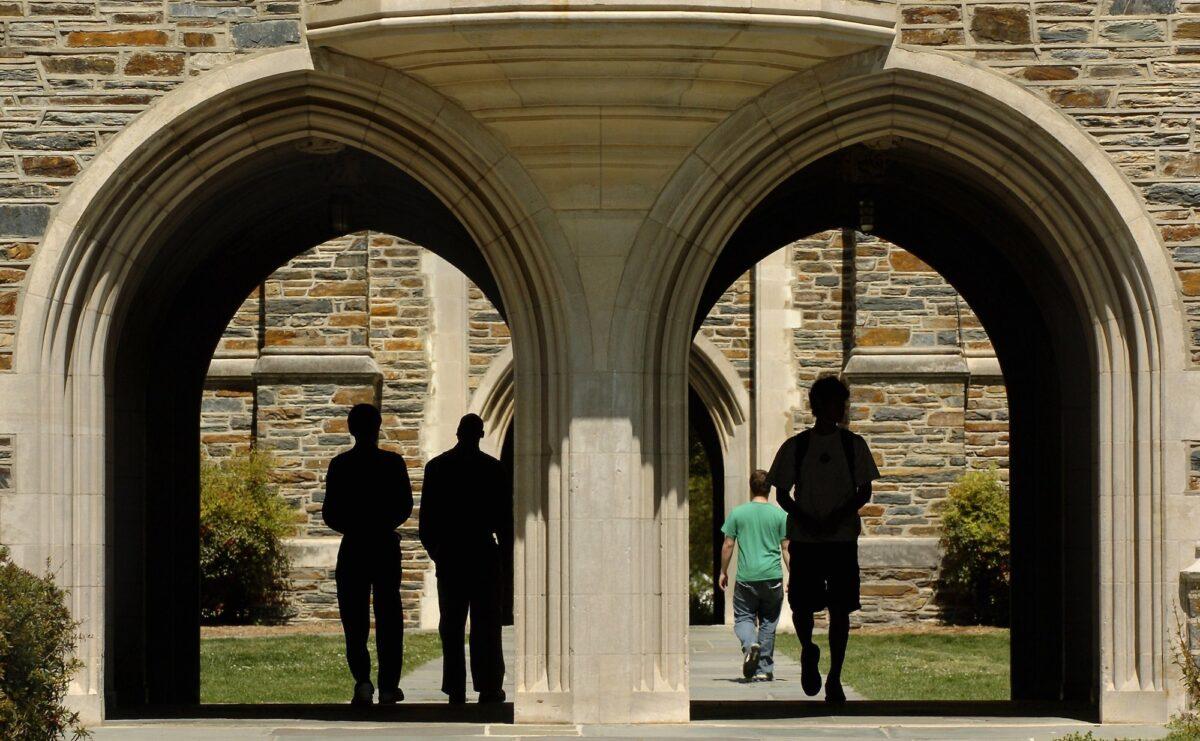 In this file photo taken in 2006, students pass under the arches at Duke University in Durham, North Carolina. (Sara D. Davis/Getty Images)