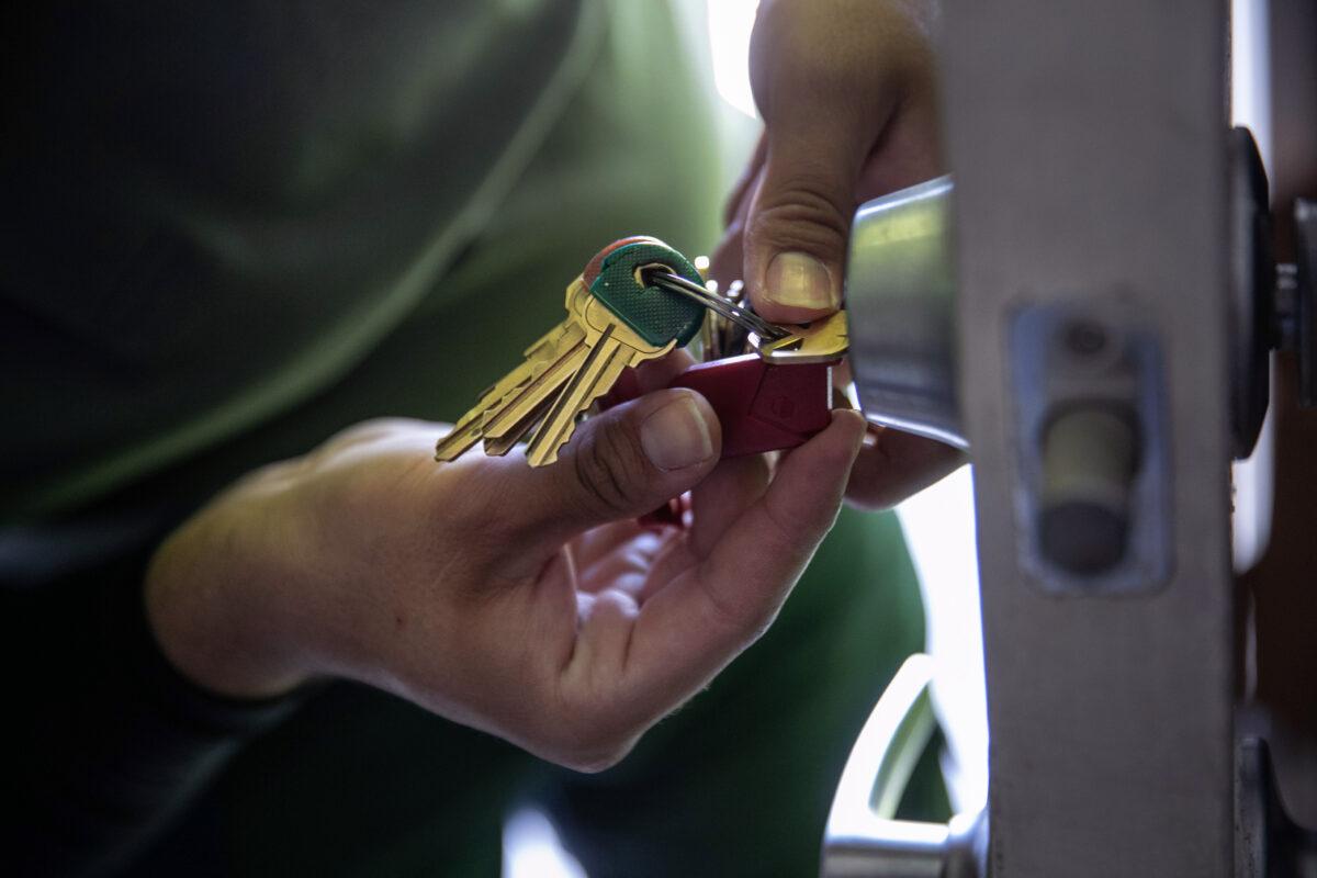 An apartment maintenance man changes the lock of an apartment after constables posted an eviction order in Phoenix, Ariz., on Oct. 7, 2020. (John Moore/Getty Images)