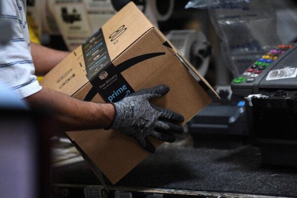 A worker assembles a box for delivery at the Amazon fulfillment center in Baltimore, Maryland, on April 30, 2019. (Clodagh Kilcoyne/Reuters)