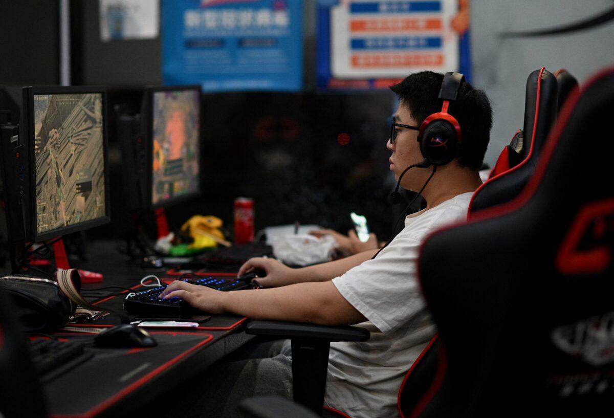 A man plays an online game at a computer shop in Beijing on Aug. 31, 2021, a day after China announced a drastic cut to children's online gaming time. (Noel Celis/AFP)
