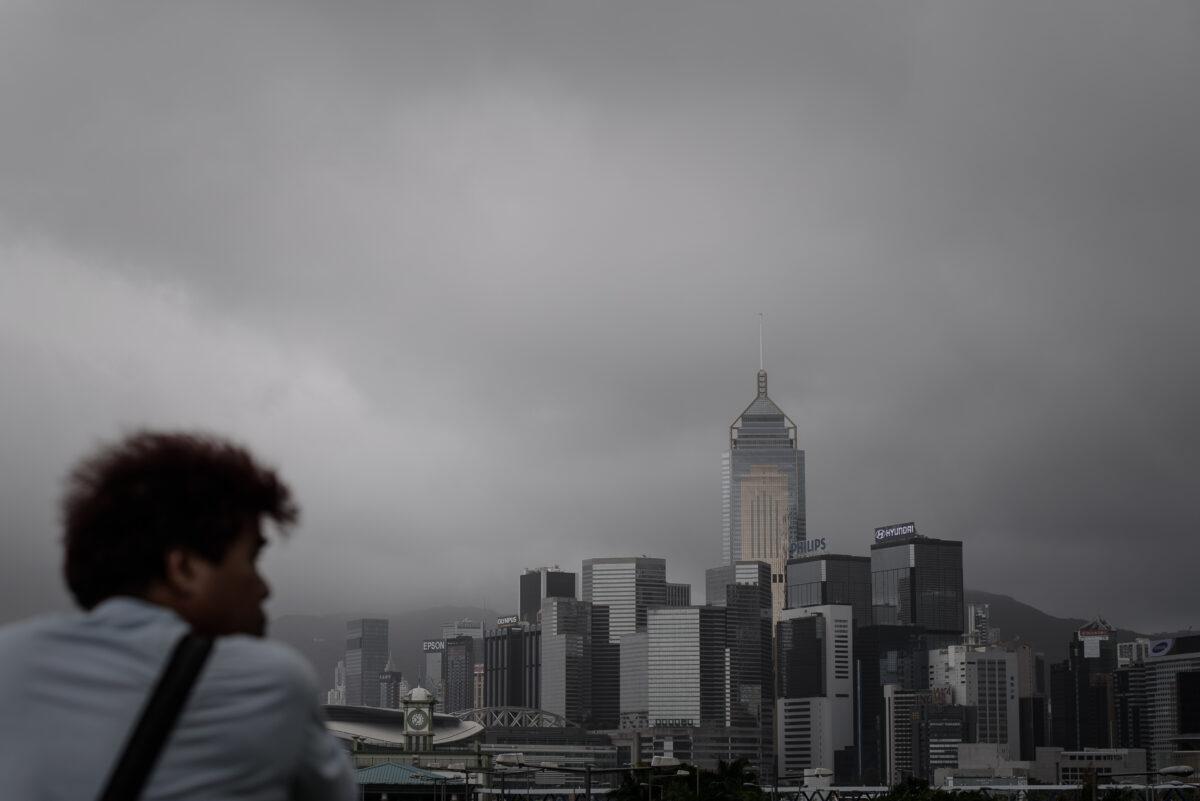 A man looks at the dark clouds over the city's skyline in Hong Kong on Aug. 14, 2013. ( Phillippe Lopez/AFP via Getty Images)