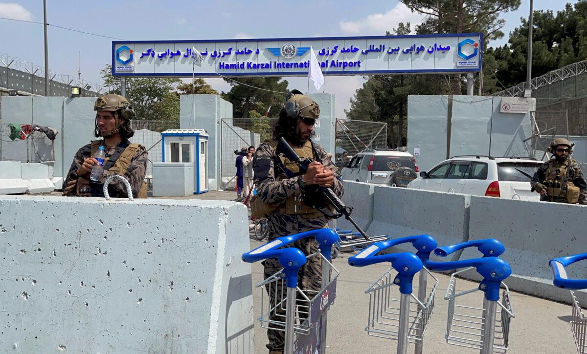 Taliban forces stand guard at the entrance gate of Hamid Karzai International Airport a day after U.S. troops' withdrawal in Kabul, Afghanistan, on Aug.31, 2021. (Stringer/Reuters)
