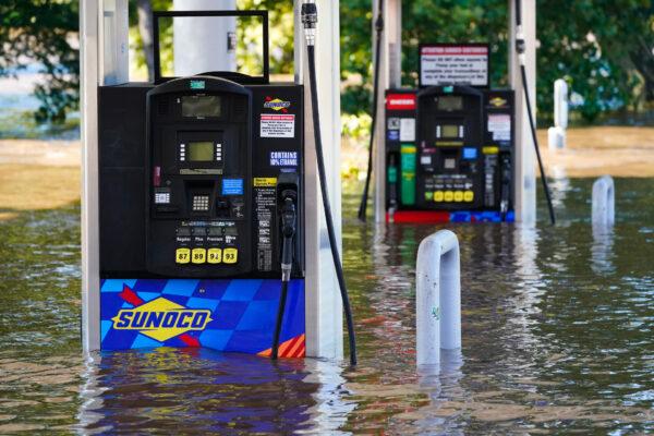 Gas pumps are submerged in water as the Schuylkill River exceeds its bank in the East Falls section of Philadelphia, on Sept. 2, 2021 in the aftermath of downpours and high winds from the remnants of Hurricane Ida that hit the area. (AP Photo/Matt Rourke)