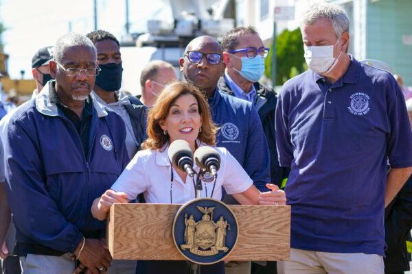 New York Gov. Kathy Hochul (C) is joined by Mayor Bill de Blasio (R) during a news conference near a home where people were killed when their basement apartment was flooded in the Jamaica neighborhood of the Queens borough of New York, on Sept. 2, 2021. (AP Photo/Mary Altaffer)
